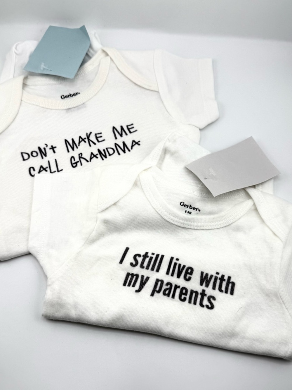 Gerber White Baby Onesies with Humorous Text (Set of 2)